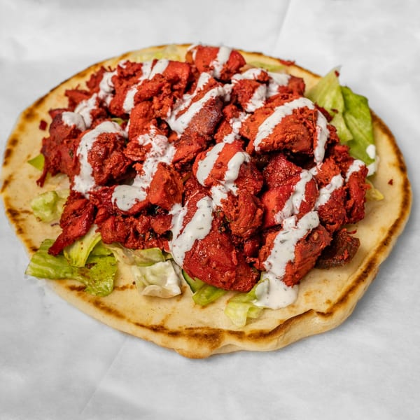 Zamzam Halal's chicken tikka on naan with lettuce and white sauce.